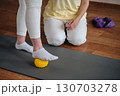 Pregnant woman training with fitness instructor doing Pilates exercises in the gym 130703278