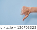 Hand showing thumbs down gesture on blue background with copy space, disapproval or dislike 130703323
