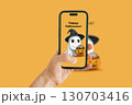 A Halloween ghost illustration on an orange background, captured with a mobile phone. 130703416