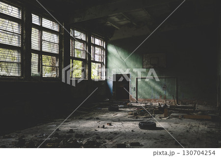 Gym at school.Old basketball hoop. Old windows.Horror concept. window silhouette. Scary bars on the windows. Gym at school.Old basketball hoop. Old windows.Horror concept. window silhouette. Scary bars on the windows. 130704254
