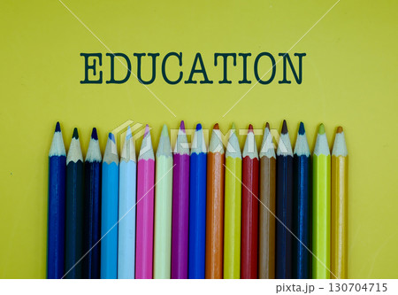 EDUCATION word on yellow background with colorful pencils EDUCATION word on yellow background with colorful pencils 130704715
