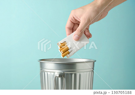 throws a pack of cigarettes into the garbage bin throws a pack of cigarettes into the garbage bin 130705188