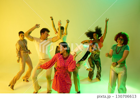Dancing group moving energetically in neon retro party celebration Dancing group moving energetically in neon retro party celebration 130706613