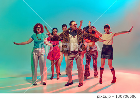 Man in fur coat leading synchronized retro dance group with confidence 130706686