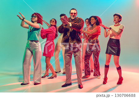 Group of stylish dancers performing synchronized disco moves. Group of stylish dancers performing synchronized disco moves. 130706688