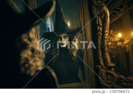 You are Boo-Tiful! An Elegant Witch Looks At Her Reflection In A Vintage Mirror In A Dark And Spooky Halloween Scene. 130706872