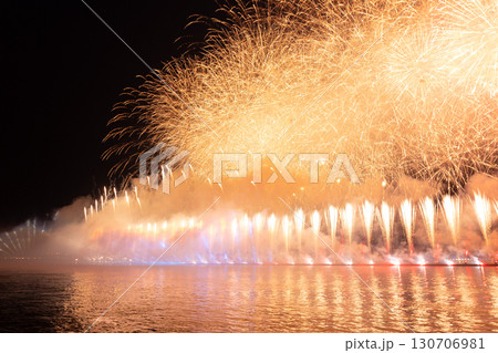 Festive colorful fireworks and illumination in dark sky with beautiful reflection in water. Holiday SCARLET SAILS. High quality photo 130706981