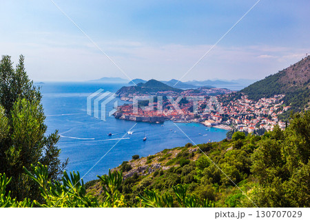 Panoramic view of Old Town medieval Ragusa and Dalmatian Coast of Adriatic Sea in Dubrovnik. Blue sea with white yachts, beautiful landscape, aerial view, Dubrovnik, Croatia. 130707029