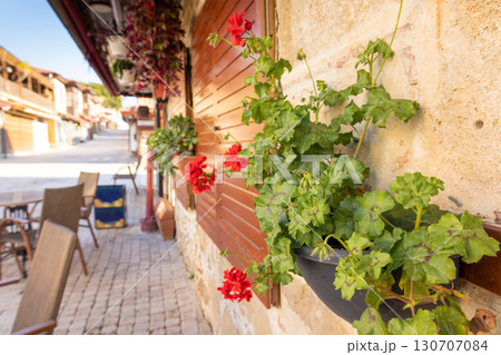 Cobbled street of old city with empty tables in street cafe, flowers in early morning, Side, Turkey. High quality photo Cobbled street of old city with empty tables in street cafe, flowers in early morning, Side, Turkey. High quality photo 130707084