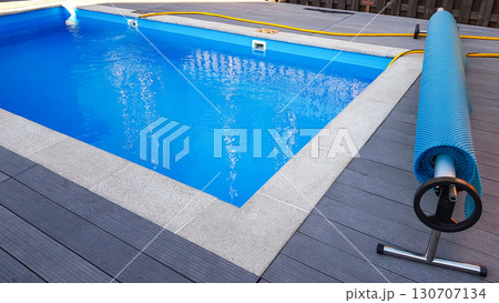 Swimming pool cover for protection against dirt, leaves, heating and cooling water, copy space 130707134
