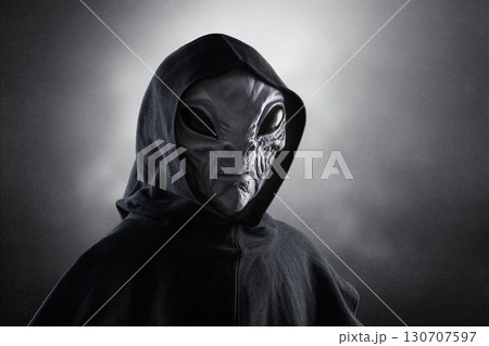 Mysterious humanoid alien at night over dark misty background Mysterious humanoid alien at night over dark misty background 130707597