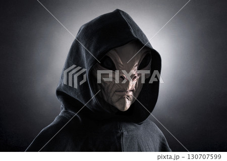 Mysterious humanoid alien at night over dark misty background Mysterious humanoid alien at night over dark misty background 130707599