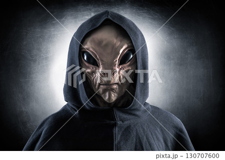 Mysterious humanoid alien at night over dark misty background  Mysterious humanoid alien at night over dark misty background  130707600