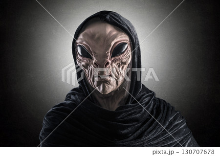 Mysterious humanoid alien at night over dark misty background  130707678