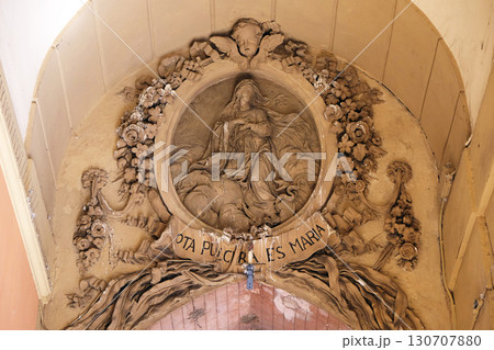 Virgin Mary relief on the house facade in Bologna, Italy 130707880