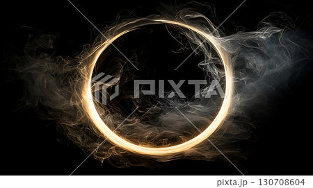 A glowing circle of smoke is in the center of a black background 130708604