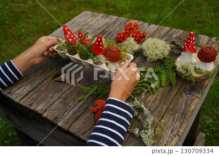 Fall-themed project made from natural and repurposed materials, featuring a mushroom design. 130709334