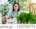 a portrait of beautiful happy asian woman traveler wearing a beautiful blue dress lifestyle enjoying in sitting coffee shop restaurant background 130709774