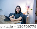 Portrait asian freelance people business female wearing glasses stylish hipster Draw or taking note on digital tablet with electronic pen for browsing internet, chatting and blogging in coffee shop. 130709779