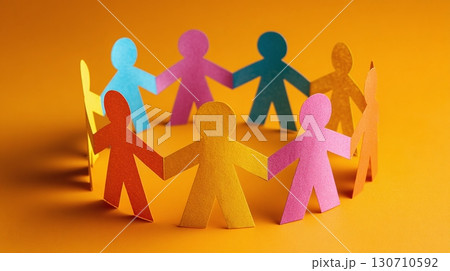 A colorful circle of paper people holding hands symbolizes unity, teamwork, and diversity. The vibrant colors against a bright background create a positive and inclusive image. A colorful circle of paper people holding hands symbolizes unity, teamwork, and diversity. The vibrant colors against a bright background create a positive and inclusive image. 130710592