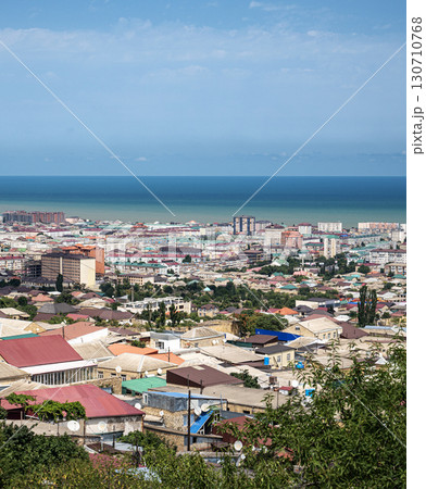 Coastal city with mix of colorful roofs and mid-rise buildings, natural daylight 130710768