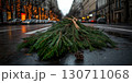Wet street scene with pine branches on rainy day in festive city setting 130711068