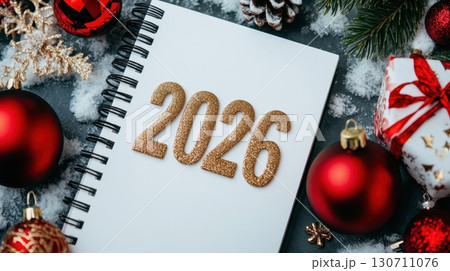 Festive new year 2026 celebration with red ornaments and snowy background 130711076