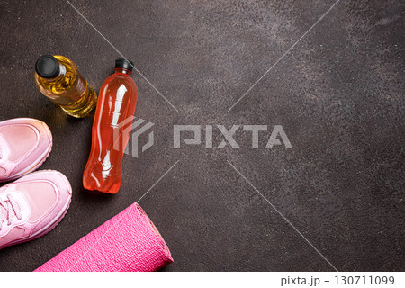 Isotonic sport drink with sneakers and fitness mat Isotonic sport drink with sneakers and fitness mat 130711099