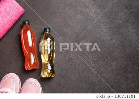 Isotonic sport drink with sneakers and fitness mat Isotonic sport drink with sneakers and fitness mat 130711101