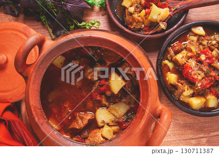 Chanakhi, a Georgian dish. in a clay pot, on a wooden table, stewed meat with vegetables, homemade, no people, Chanakhi, a Georgian dish. in a clay pot, on a wooden table, stewed meat with vegetables, homemade, no people, 130711387
