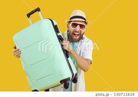 Funny emotional man with suitcase is happy because he is going on summer vacation. Funny emotional man with suitcase is happy because he is going on summer vacation. 130711616