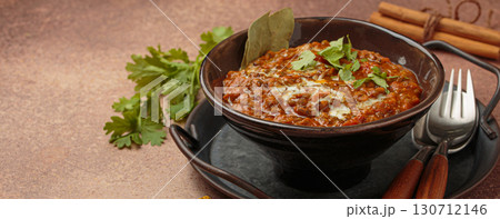 Dal makhani with cream and coriander in bowl is served with spices, traditional dish of India, space for text Dal makhani with cream and coriander in bowl is served with spices, traditional dish of India, space for text 130712146