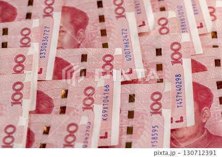 the number 100 on a group of red Chinese yuan folded together, the face value of Chinese money folded together, a large amount of money is the Chinese national currency 130712391