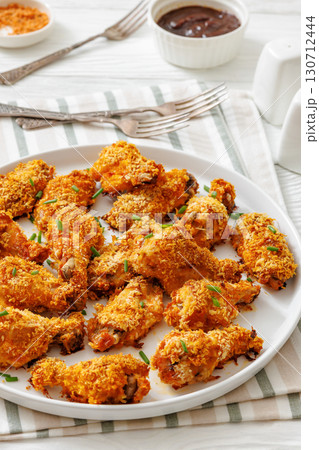 Panko breaded oven baked chicken wings on plate 130712444