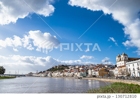 Alcacer do Sal, Portugal view from across the Sado River with Santiago Church on the right and Castle on the left Alcacer do Sal, Portugal view from across the Sado River with Santiago Church on the right and Castle on the left 130712810