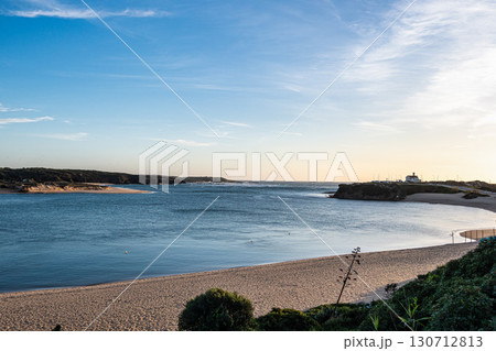 Praia do Farol in Vila Nova de Milfontes, Portugal is located at the mouth of the Mira River on the northern bank. Praia do Farol in Vila Nova de Milfontes, Portugal is located at the mouth of the Mira River on the northern bank. 130712813