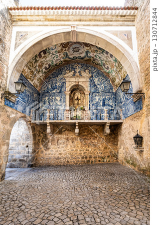 Porta da Vila is the main entrance to Obidos, Portugal. Double door with balcony. Inside azulejos Porta da Vila is the main entrance to Obidos, Portugal. Double door with balcony. Inside azulejos 130712844