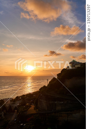 The view of the mountain and the ocean at sunset. A sunny path over the sea. 130713297