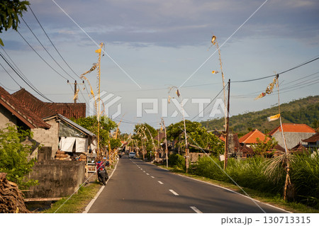 The road decorated for the holiday in the village. Bamboo decorations along the road. The road decorated for the holiday in the village. Bamboo decorations along the road. 130713315