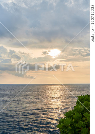 The view of the mountain and the ocean at sunset. A sunny path over the sea. The view of the mountain and the ocean at sunset. A sunny path over the sea. 130713338