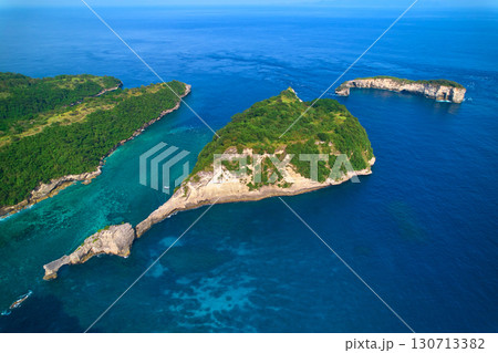 Cinematic aerial landscape shots of the beautiful island Diamond beach of Nusa Penida. Huge cliffs by the shoreline and hidden dream beaches with clear water. 130713382