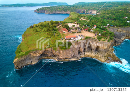 Cinematic aerial landscape shots of the beautiful island of Nusa Penida. Huge cliffs by the shoreline and hidden dream beaches with clear water. 130713385