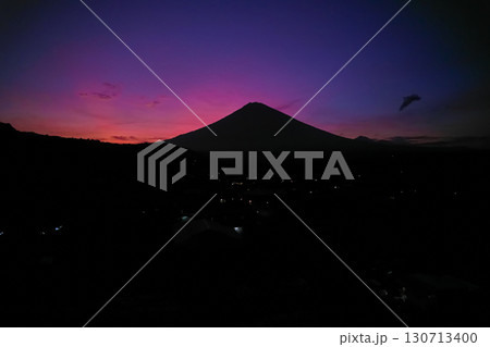 Silhouette of the Agung volcano at sunset. Panorama of the mountain on the island of Bali. Silhouette of the Agung volcano at sunset. Panorama of the mountain on the island of Bali. 130713400