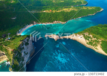 Cinematic aerial landscape shots of the beautiful island Diamond beach of Nusa Penida. Huge cliffs by the shoreline and hidden dream beaches with clear water. Cinematic aerial landscape shots of the beautiful island Diamond beach of Nusa Penida. Huge cliffs by the shoreline and hidden dream beaches with clear water. 130713402