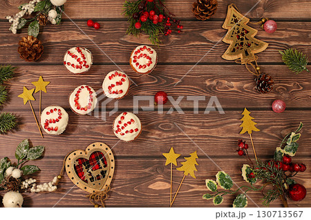 Winter background for greeting card. Curd muffins with pomegranates in glaze with numbers 2026 for festive table, idea for food decoration and New Year's dishes for children. Winter background for greeting card. Curd muffins with pomegranates in glaze with numbers 2026 for festive table, idea for food decoration and New Year's dishes for children. 130713567