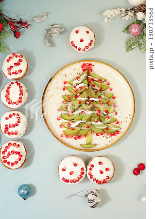 Christmas and New Year dishes. Curd muffins with pomegranates in glaze with numbers 2026 and a kiwi tree for a festive table, an idea for decorating food and decorating New Year dishes for children Christmas and New Year dishes. Curd muffins with pomegranates in glaze with numbers 2026 and a kiwi tree for a festive table, an idea for decorating food and decorating New Year dishes for children 130713568