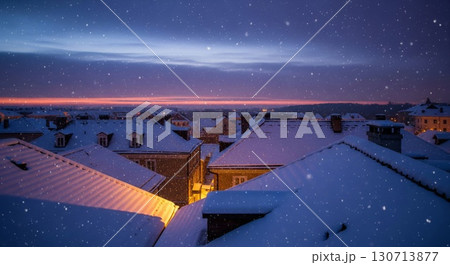 Snow Covered Rooftops at Dusk with Falling Snow in a Cityscape View 130713877