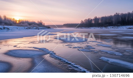 Frozen River At Sunset With Snow Covered Banks And Forest Background 130714696