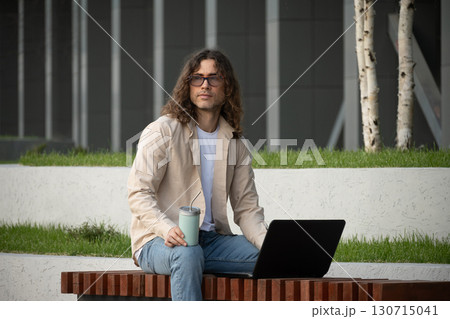 Man, student and freelancer thinks and working by laptop on outdoor bench for remote work Man, student and freelancer thinks and working by laptop on outdoor bench for remote work 130715041