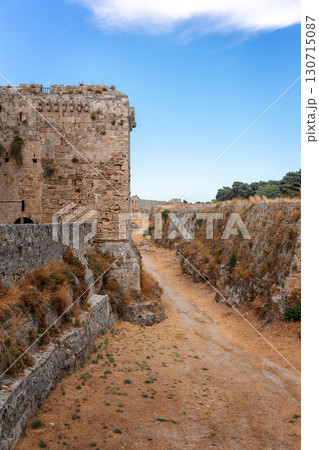 Stone powerful walls of old city, the ancient defense of Old Town, Rhodes, Dodecanese, Greece. High quality photo Stone powerful walls of old city, the ancient defense of Old Town, Rhodes, Dodecanese, Greece. High quality photo 130715087
